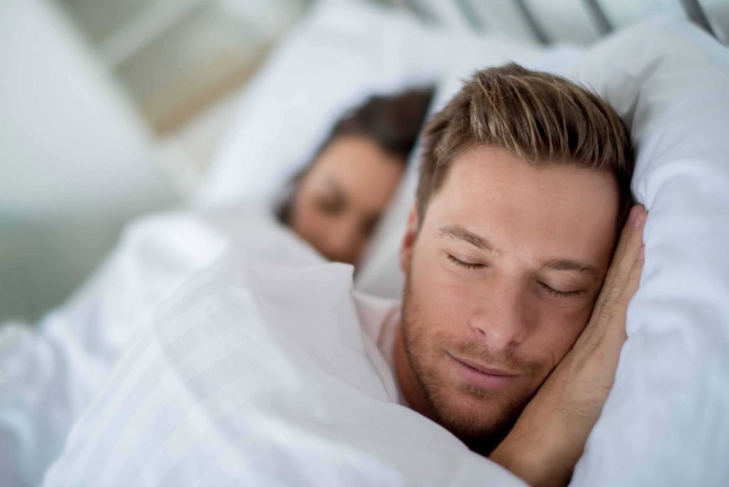 Paar schläft im Doppelbett
